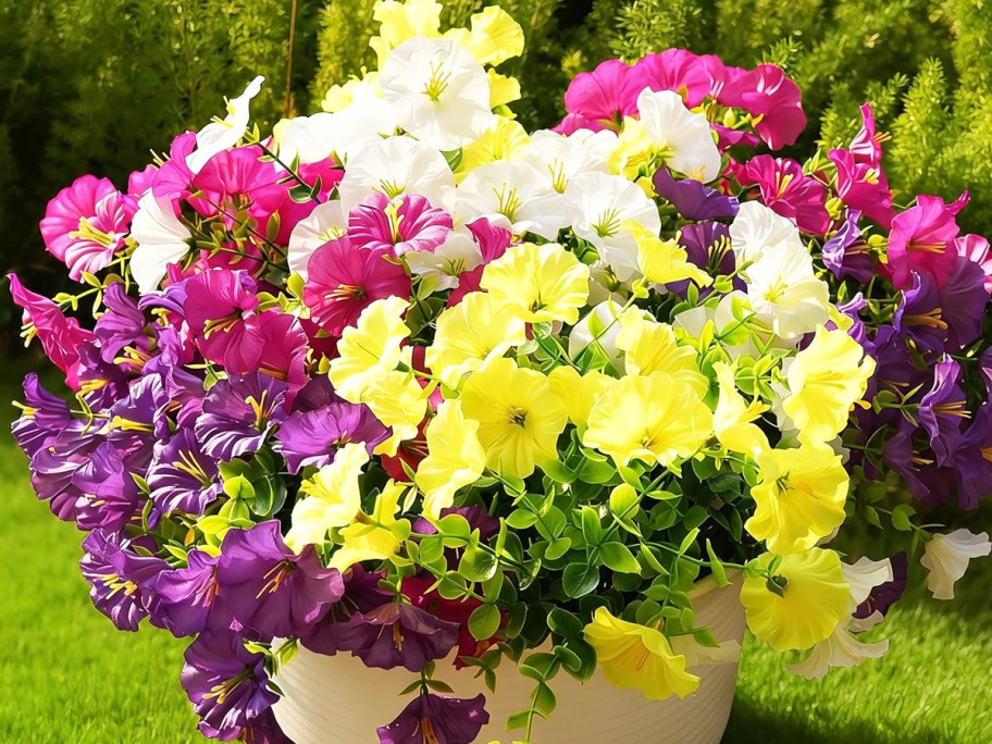 colorful artificial flowers in a white pot