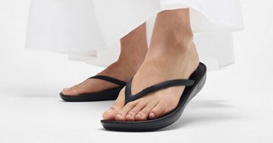 woman wearing FitFlop Women's IQushion Ergonomic Flip Flops