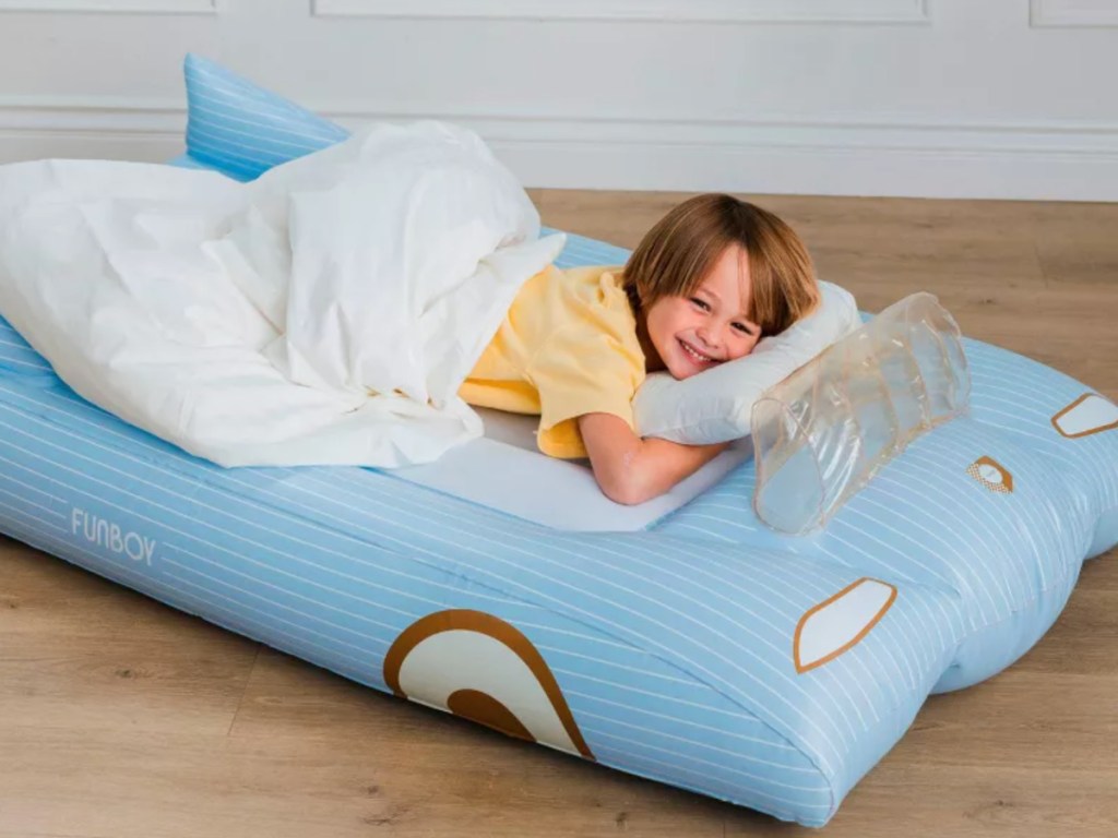 Little boy sleeping on blowup kids, air mattress shaped like a car
