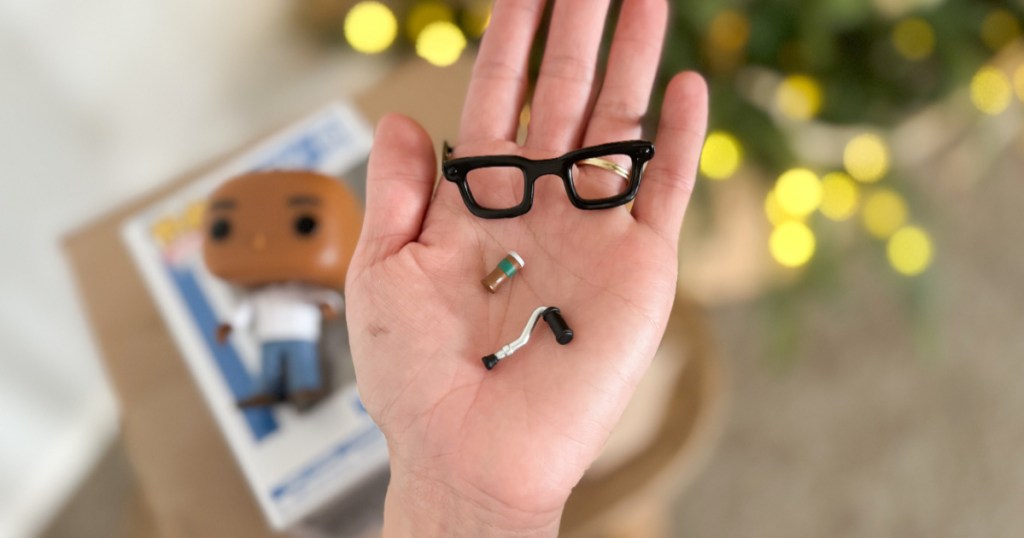 Hand holding Funko pop accessories