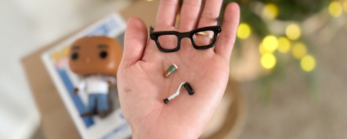 Hand holding Funko pop accessories