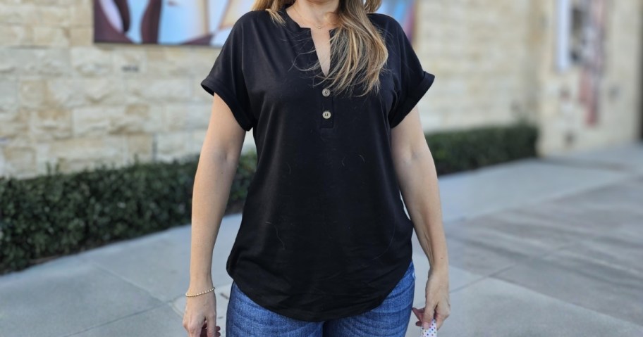 woman wearing GKBK buttoned short-sleeve top in black