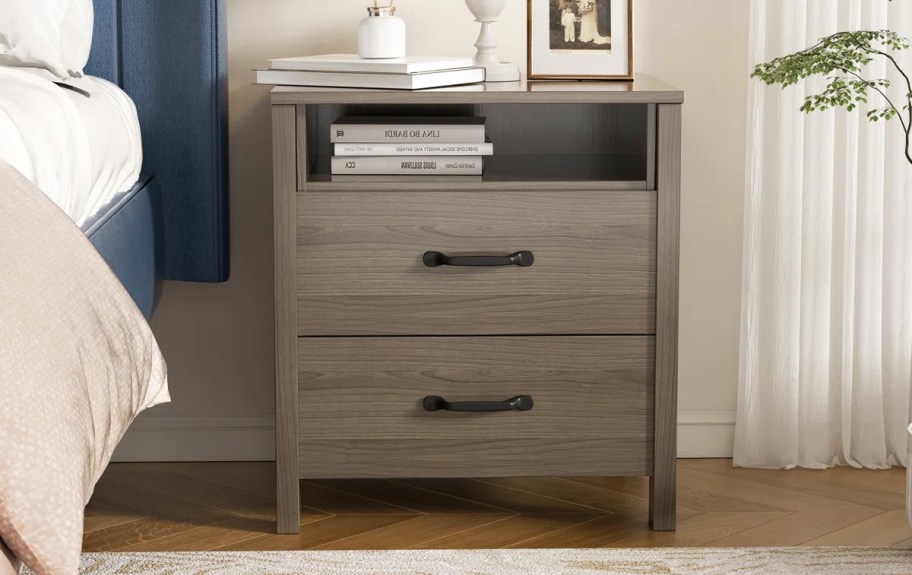 wood 2 drawer nightstand next to bed