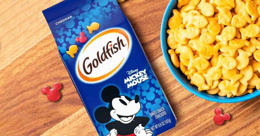 blue bag of Goldfish Disney Mickey Mouse Crackers on table near bowl of goldfish