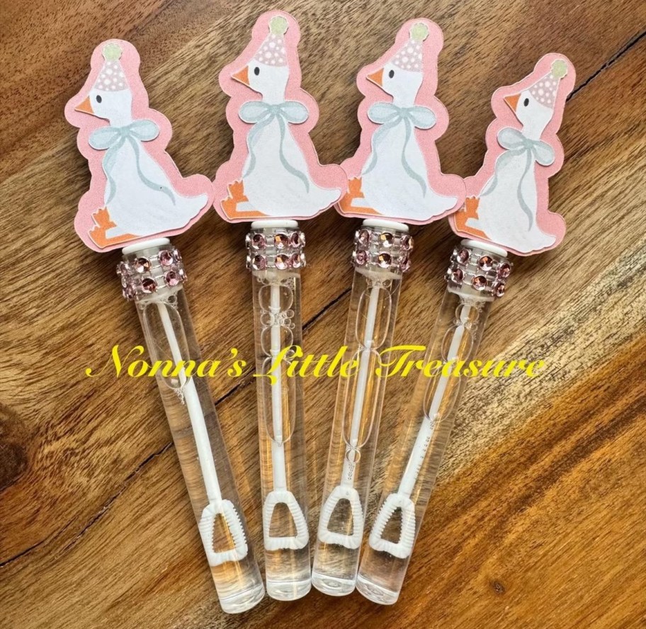 Four double bonds with pink birthday goose decor on top 