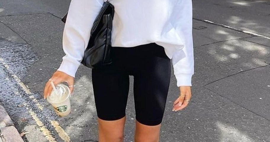 woman wearing black bike shorts and white sweatshirt