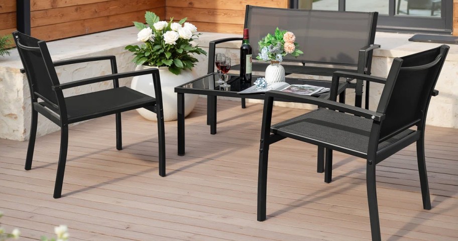 black conversation set with chairs, loveseat, and table