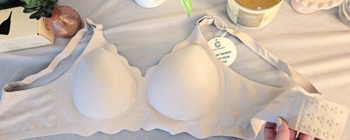 White jelly bra on cloth blanket next to candle and plant