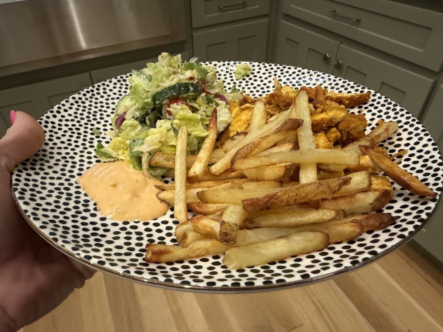plate of jesse & ben's beef tallow french fries with sauce and salad 