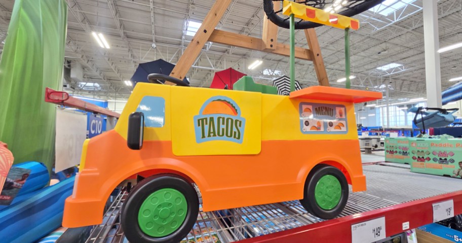 orange and yellow taco truck ride on toy on display in store