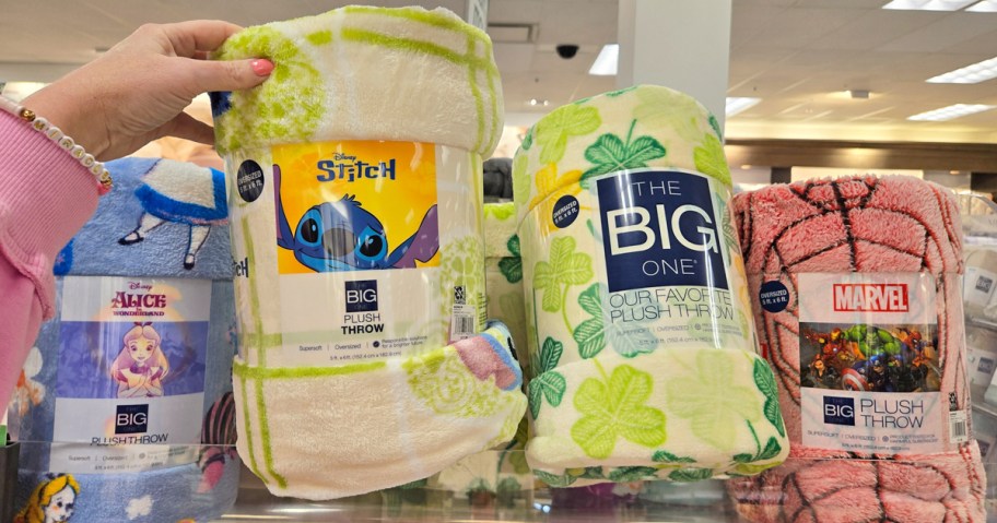 hand grabbing stitch print blanket from shelf