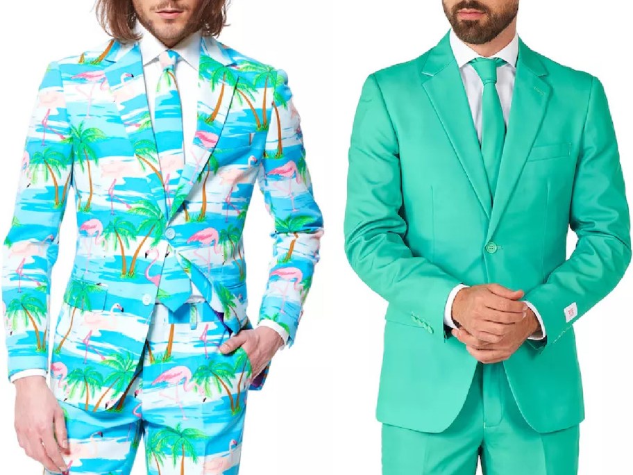 Two men in colorful suits. The left suit features a tropical print with flamingos and palm trees on blue, while the right suit is solid turquoise.