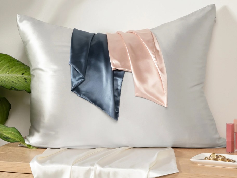 pillow with multiple silk pillowcases on it