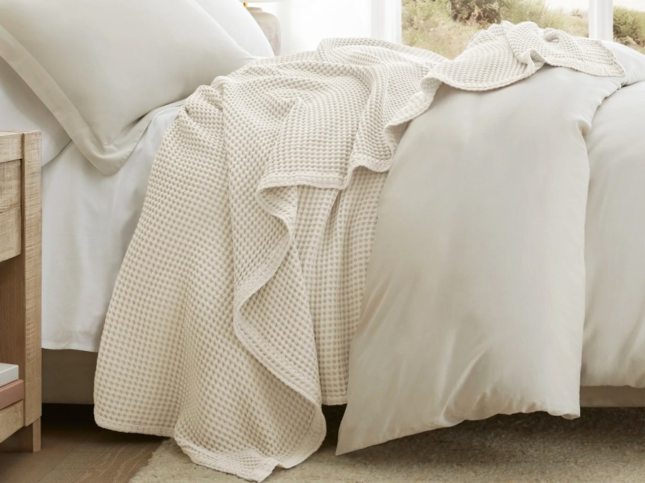 white blanket and bedding on a bed