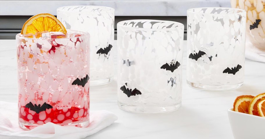 white drinking glasses with black bat icons