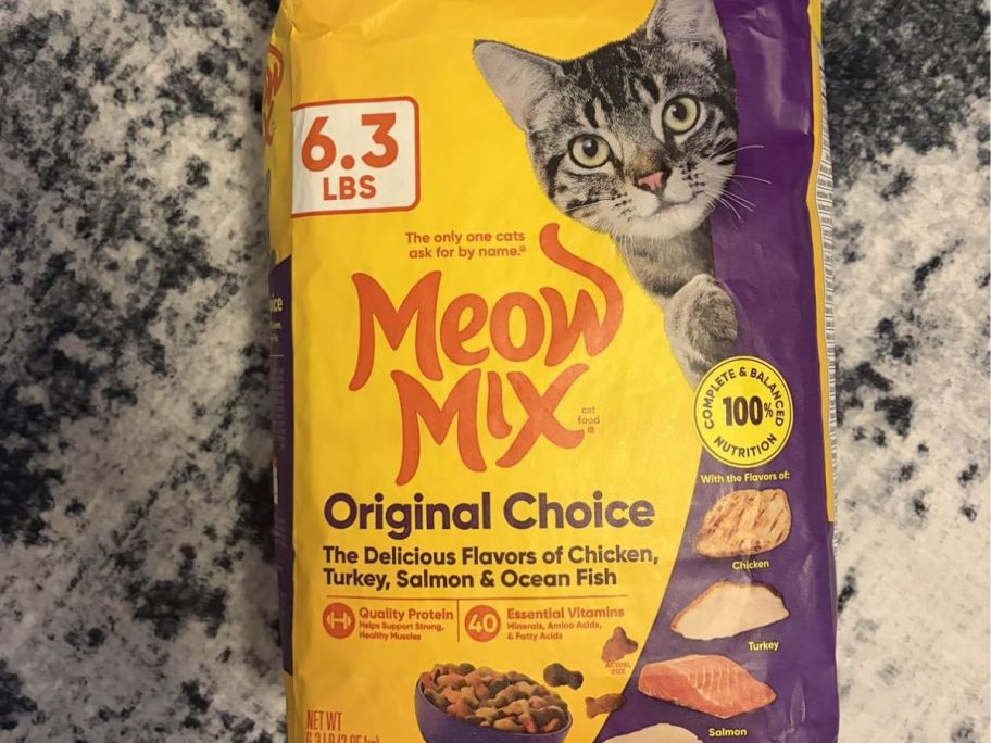 Meow mix 6.3lb bag on top of a carpet