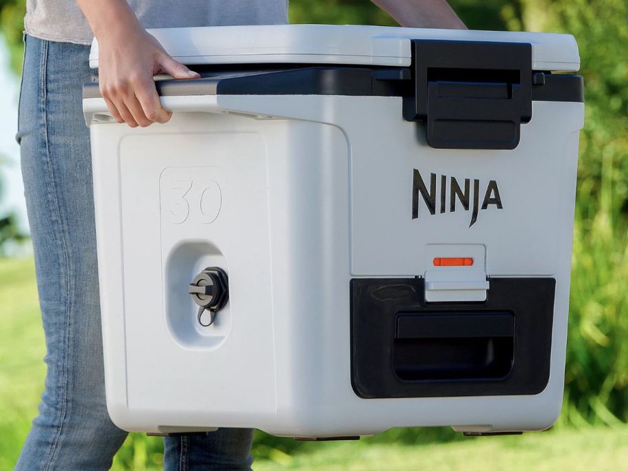 person carrying white Ninja FrostVault 30Qt Hard Cooler w/ Dry Zone