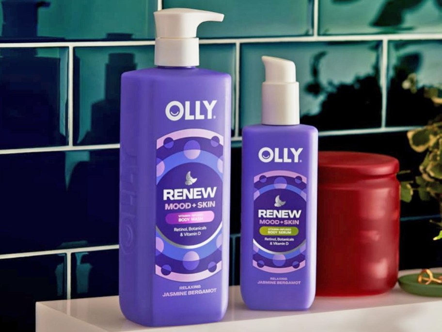 purple bottles of OLLY Renew Body Wash and Lotion in bathroom