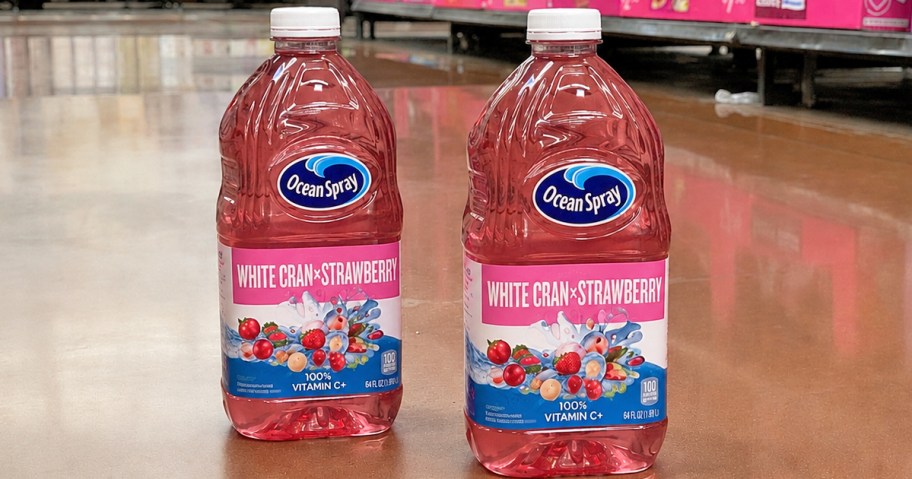 pink bottles of Ocean Spray White Cran-Strawberry Juice on floor of store