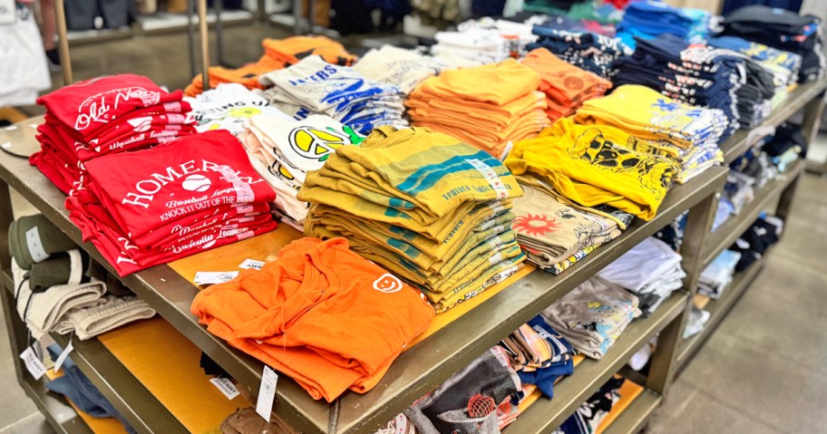 display table full of colorful graphic tees