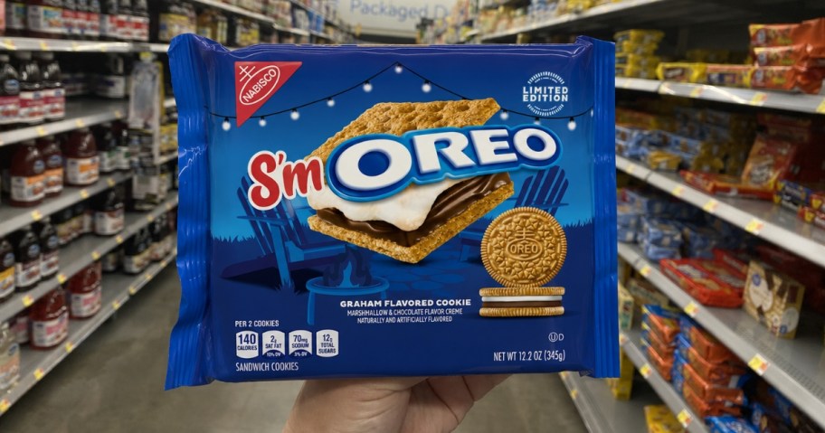 person holding package of s'moreo oreo cookies in store