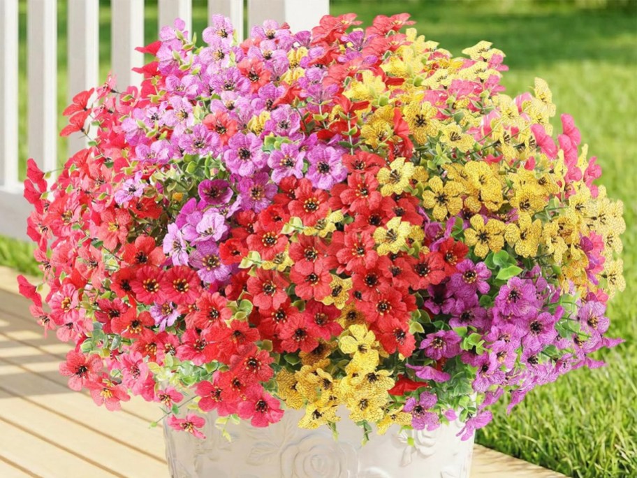 colorful artificial flowers in a white pot