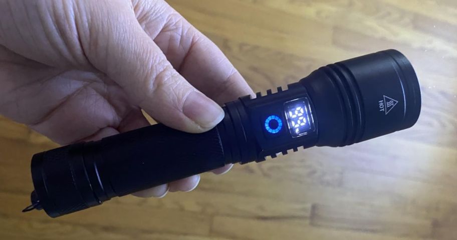 Hand holding a rechargeable LED Flashlight