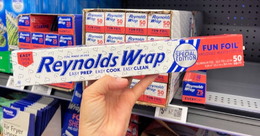 hand holding Reynolds Wrap Fun Foil Heart pattern in walmart store