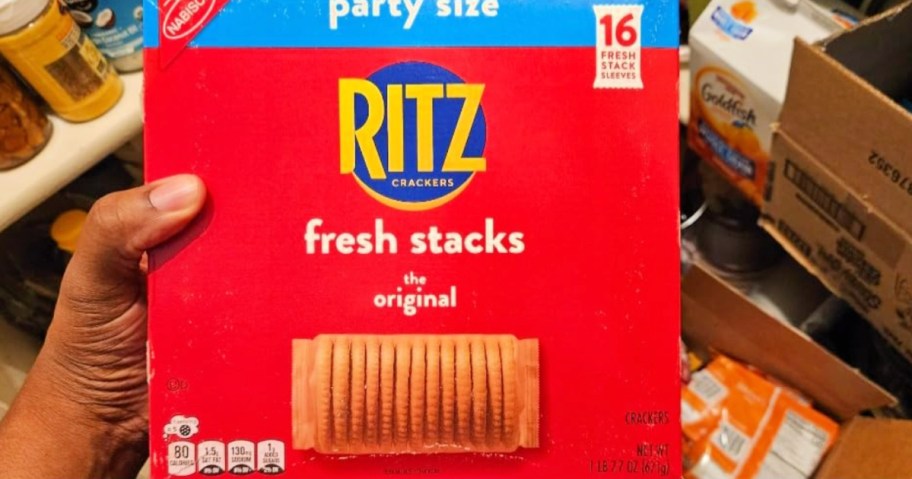 Hand holding up box of Ritz, fresh stacks party size