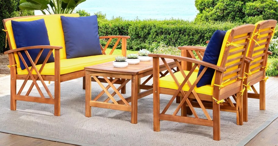wood chairs, loveseat, and table set with yellow cushions