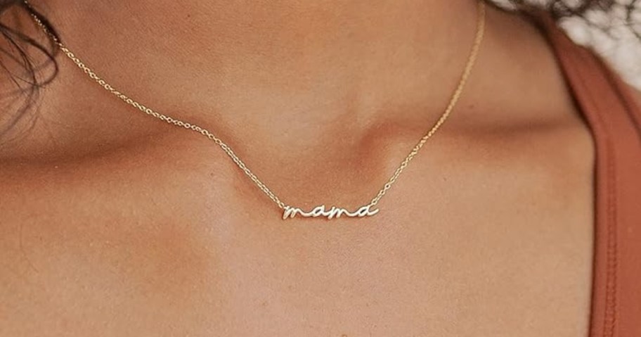 woman wearing dainty mama necklace in gold finish