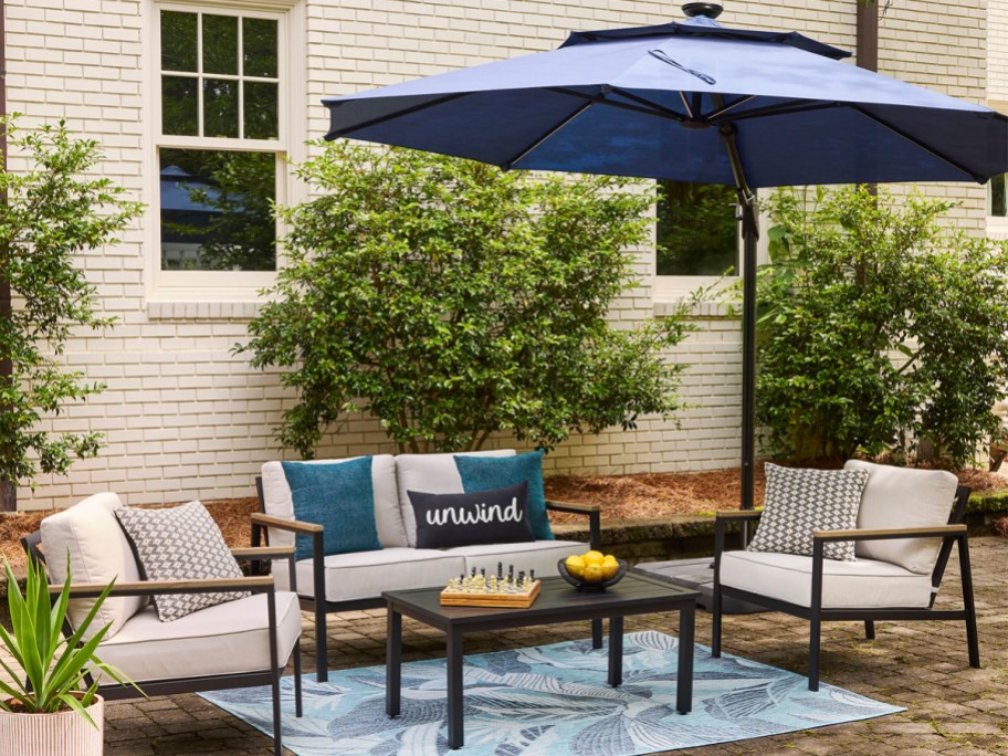 navy blue cantilever umbrella hanging over a patio set