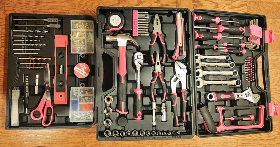 black and pink tool set kit on a wood table