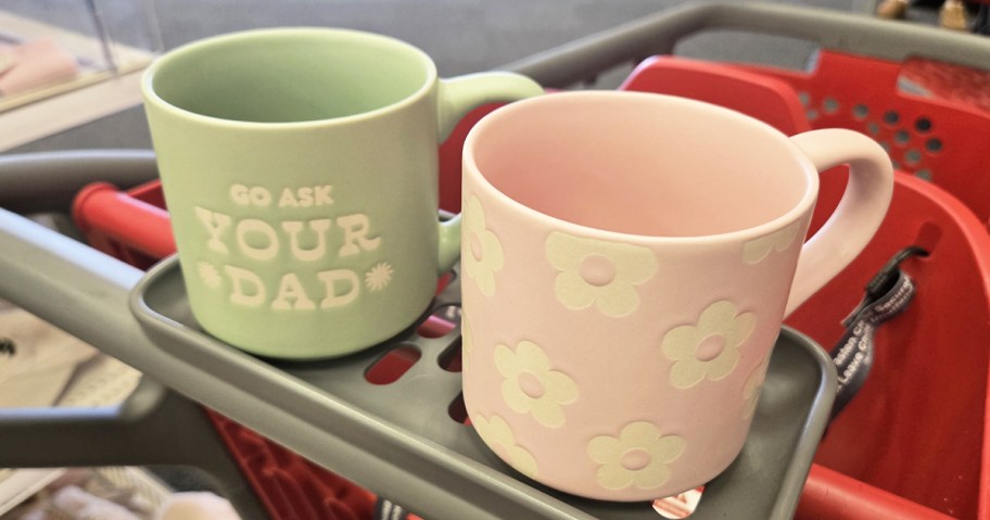 green and pink mugs in a red target shopping cart