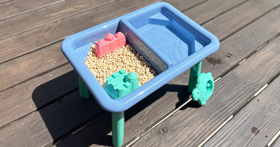 blue water table filled with cherrios 