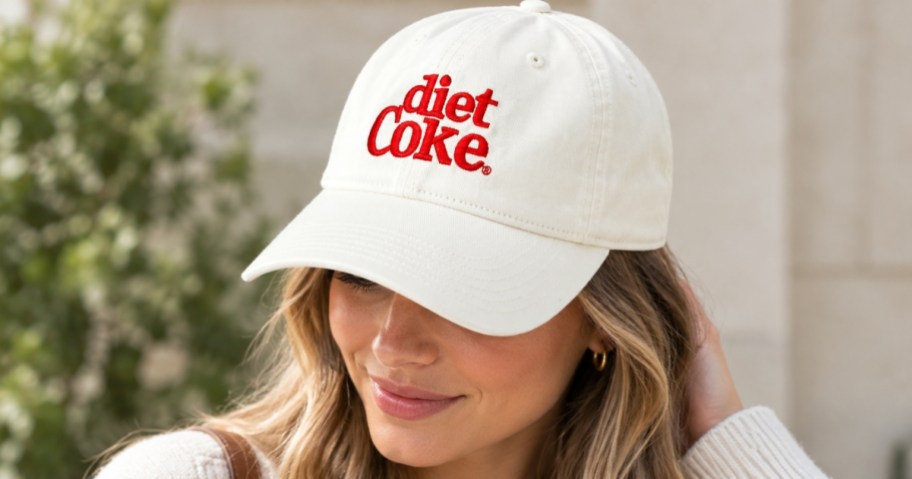 woman wearing white diet coke hat outside