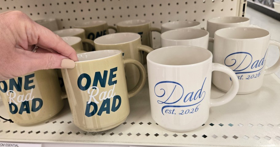 hand grabbing coffee mug from store shelf