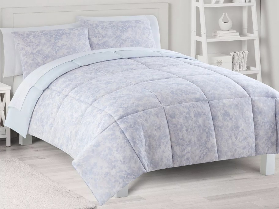 purple marbled comforter set on a bed