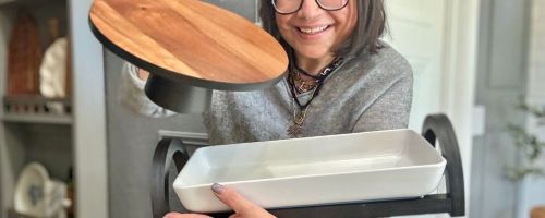 lina holding The Cellar Wood Cake Stand and Multi-Function Server