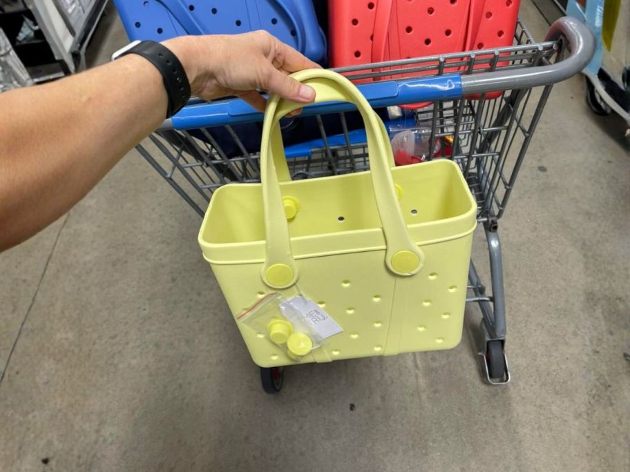 hand holding Time and Tru Women's Mini Beach Tote Bag&nbsp;in store
