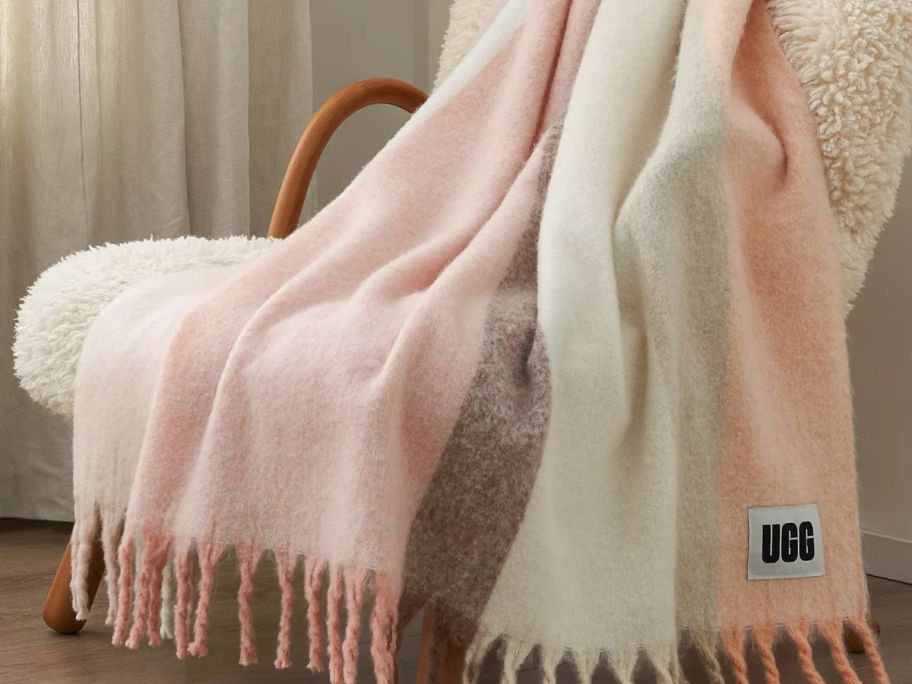 Ugg throw blankets in different colors on top of a chair
