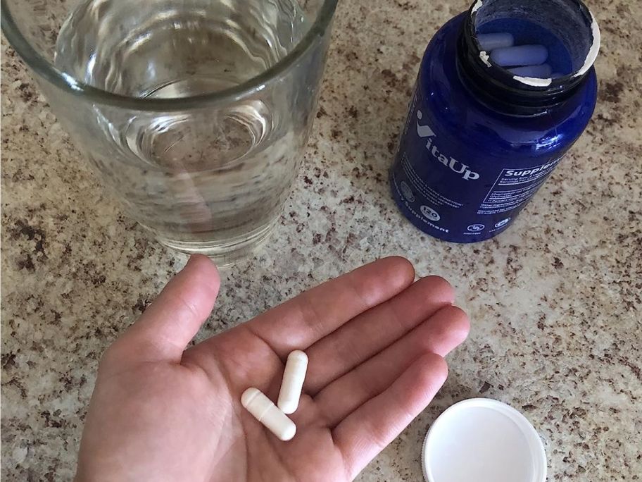 Hand holding VitaUp Magnesium caplets