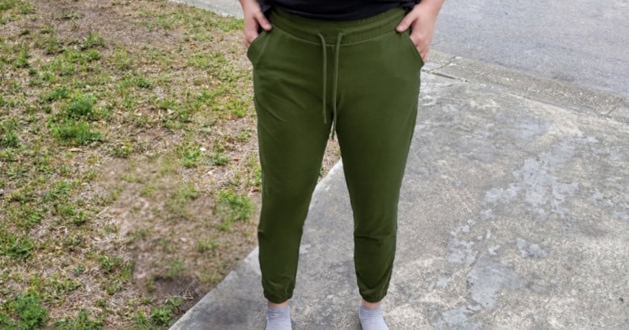 woman wearing walifrey women's joggers in green outside standing on driveway