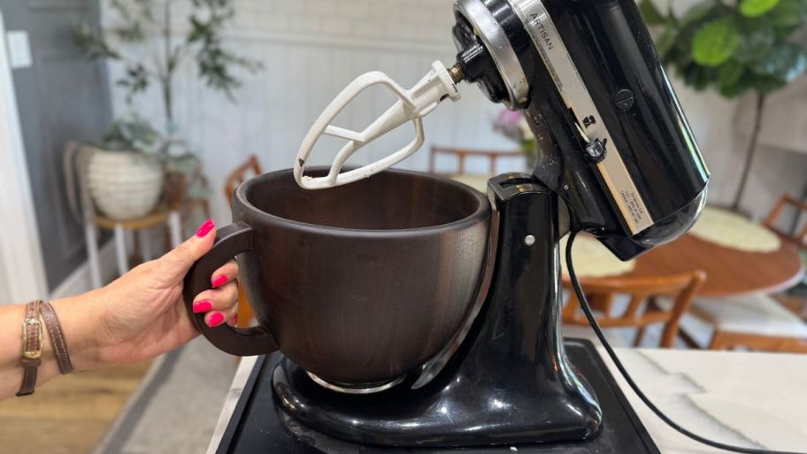 hand holding Wood bowl on the mixer
