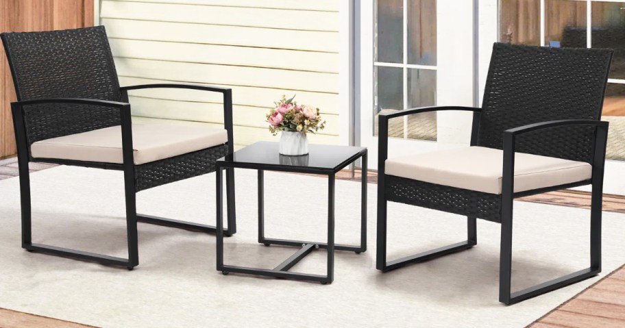 black patio chairs and matching side table