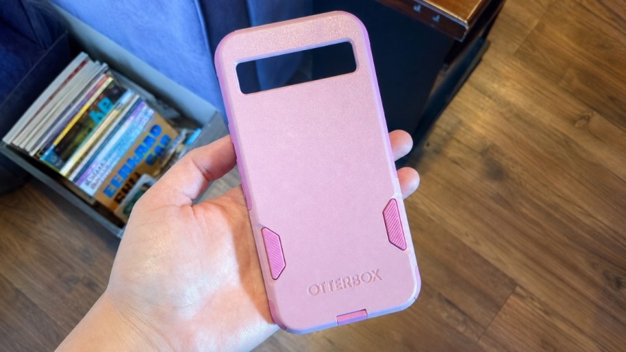 a hand holding a pink phone case