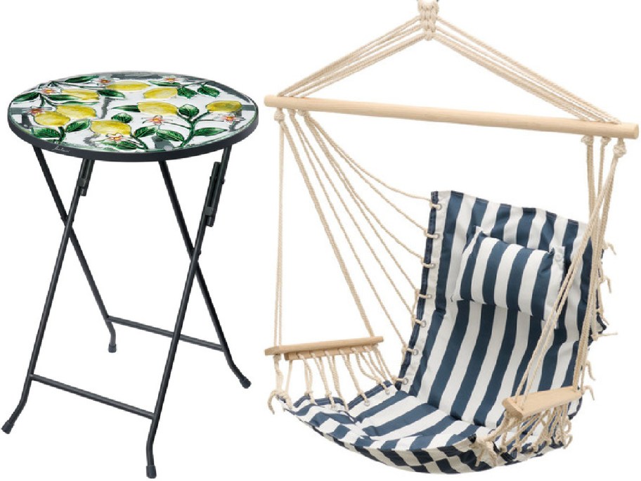 A round folding table with a colorful lemon pattern sits beside a blue and white striped hammock chair.
