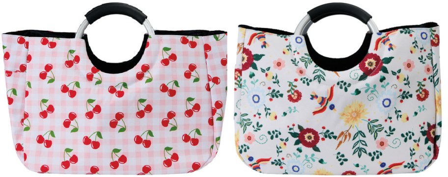 Two tote bags with black handles. The left bag features a red cherry pattern on a pink gingham background. The right bag displays a colorful floral design.