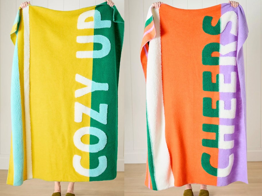 people holding yellow and orange blankets 