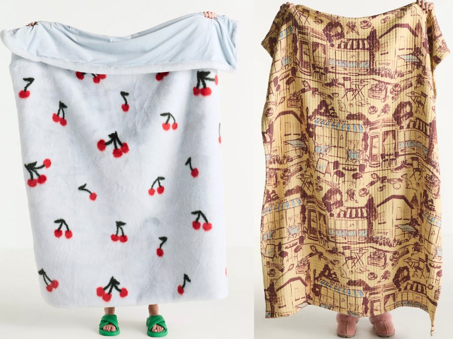 people holding up blue cherry and tan blankets 